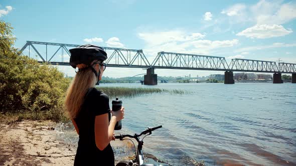 Cyclist Fitness Riding On Road Bike And Drinking Water. Triathlon Girl  Cycling Workout.