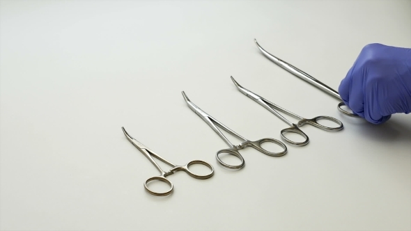 Surgical Nurse Puts Medical Surgery Tools On Table