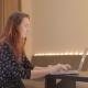 Young Woman Working At a Laptop At Home - VideoHive Item for Sale