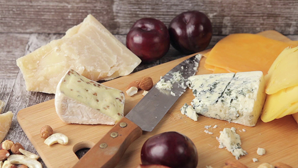 Cheese And Fruits On Wooden Plate