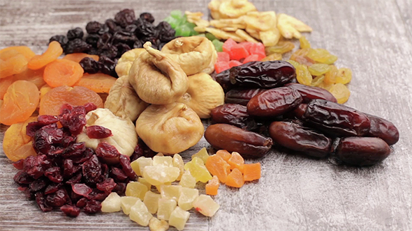 Mix Of Dried Nuts And Fruits On Wooden Background