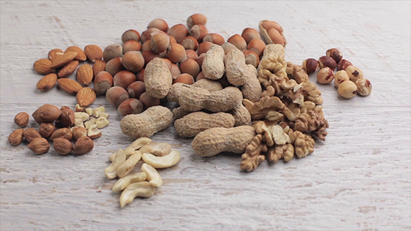 Different Type Of Raw Nuts On White Background