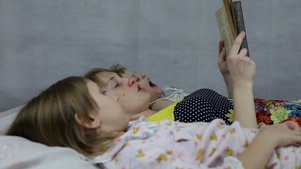 Mom Reading the Book to Son and Daughter Bedtime