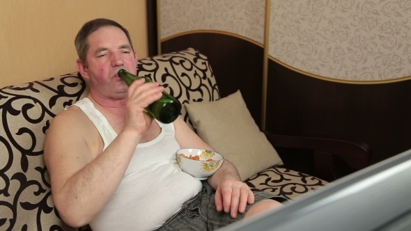 Man Drinking Beer At Home And Snack Potato Chip