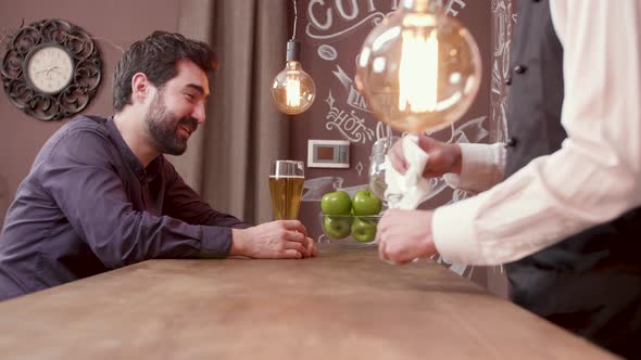 Man Laughs and Having Fun While Drinking a Glass of Beer