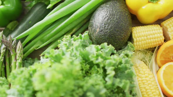 Video of fresh fruit and vegetables over wooden background