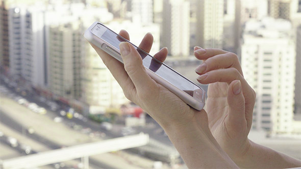 Woman in Big City Using Phone