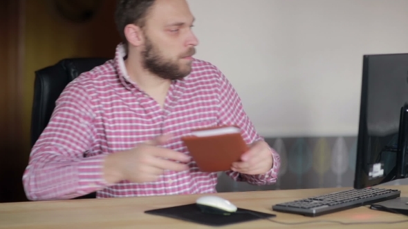 Man Checked With a Diary At The Computer 