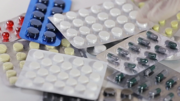 Male Hand With a Pack of Medicine Tablets