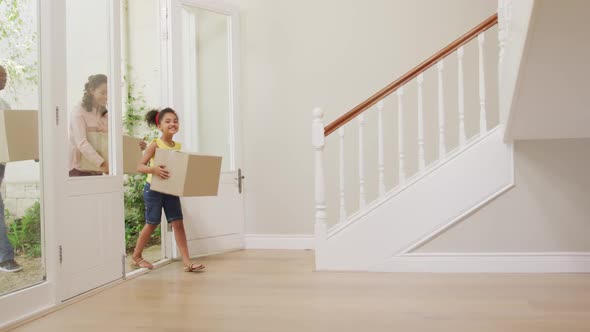 African American couple and their daughter moving into new house