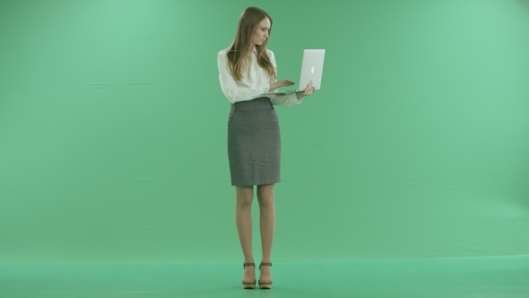 Business Woman Typing On Laptop On Green Screen