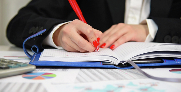 Businesswoman Making A Note In The Diary