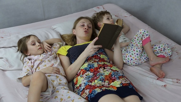 Mom Reading the Book to Son and Daughter Bedtime