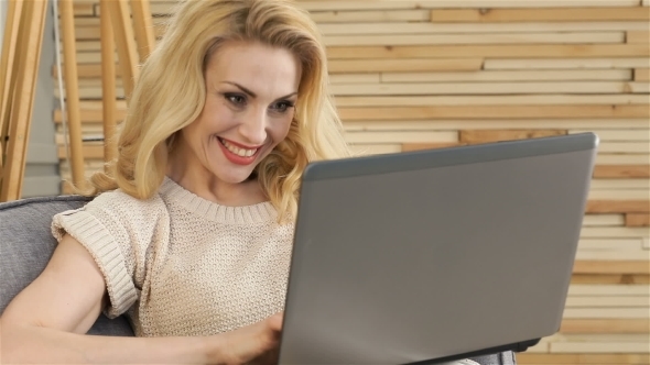 An Attractive Girl With a Laptop On Her Lap