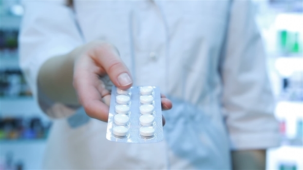 Young Woman Pharmacist With Pills