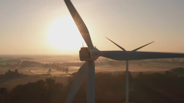 Aerial View of Wind Turbines Standing in a Wheat Field at Sunset