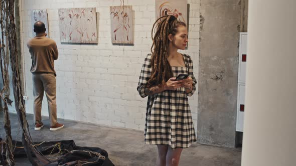 Girl with Dreadlocks in Art Gallery