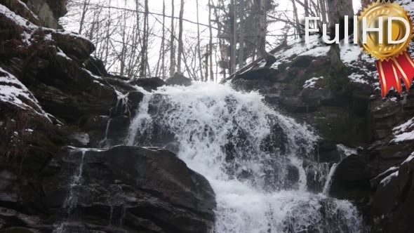 Fast Flowing Water in a Waterfall During Winter