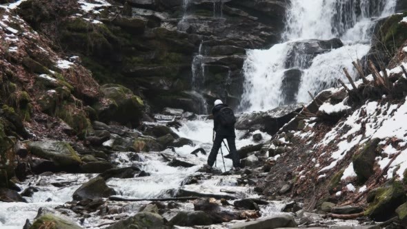 Photographer Making Photo of Winter Waterfalls