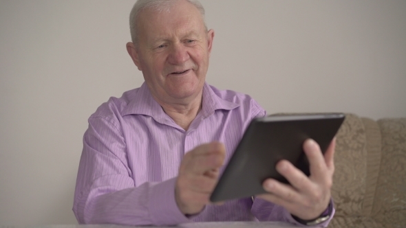 A Man Working With a Tablet In a Room 