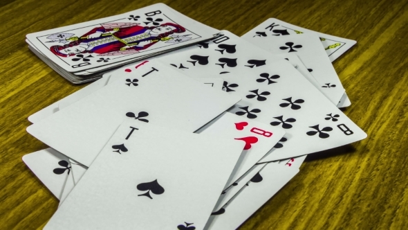 Playing Cards Moving And Rotate On a Wooden Table