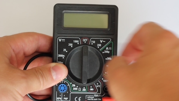 Man Measures Digital Multimeter 