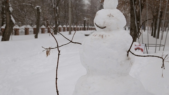 Snowman in the Park in Winter alt