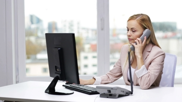 Angry Businesswoman With Computer And Telephone