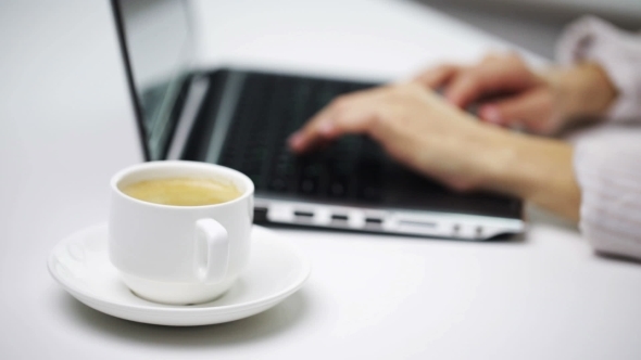 Businesswoman With Laptop And Coffee At Office