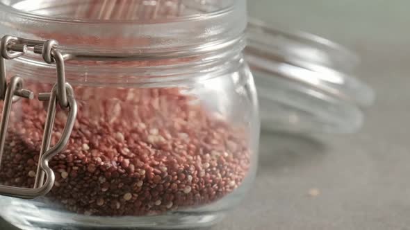 Red raw quinoa in glass jar