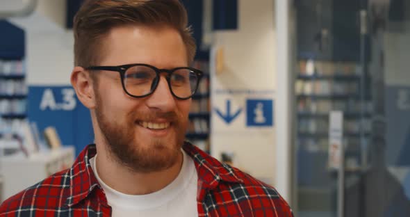 Close Up of Smiling Hipster Male Student Walking in Library