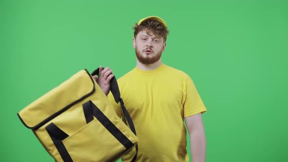 Portrait of Young Men Looking at Camera and Putting Thermo Bag on His Shoulder