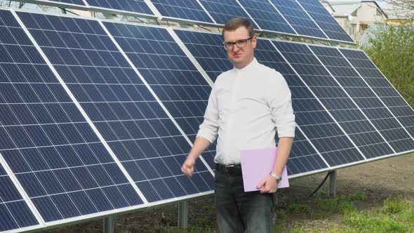 Successful Young Businessman on the Background of a Solar Power Station