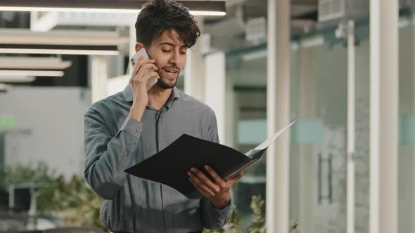 Busy Arab Man Businessman Worker in Office Workspace Talking Mobile Phone Answer Call Consulting