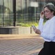 Smiling Female Professional Talking on Smart Phone Outside Office Building - VideoHive Item for Sale