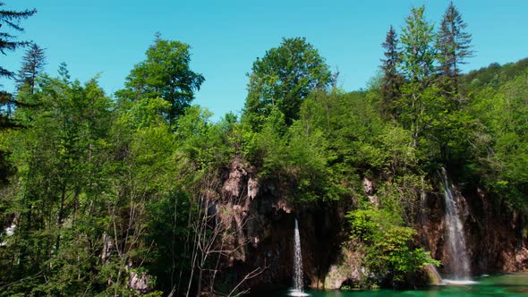 National park in Croatia of turquoise lagoon with waterfalls in sunny day.