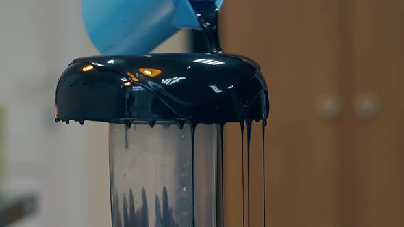 Confectioner Pours Thick Layer of Dark Chocolate on Doughnut