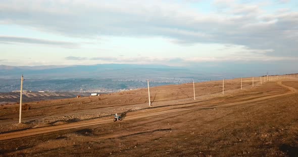 Aerial follow shot on motorcycle speed riding while sunset with beautiful landscape