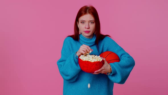 Redhead Young Woman Basketball Fan Eating Popcorn Doing Winner Gesture Celebrating Victory Win