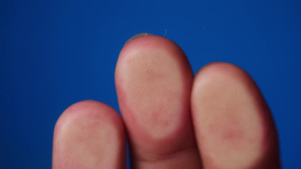 Human Hand Making Fingerprints on Blue Background