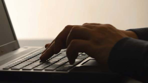 A Human Hands Typing on a Laptop