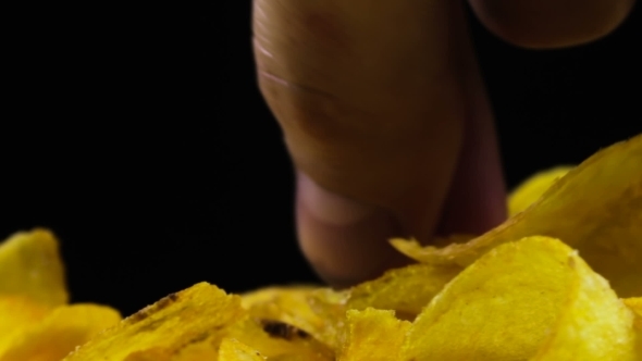 Potato Chips Rotating On Black Background