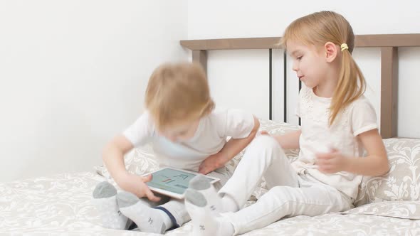 Sweet Caucasian Children Use Modern Gadget, Holding Tablet in Hands