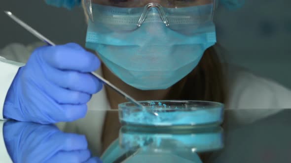 Lab Assistant in Safety Glasses Checking Blue Chemicals, Household Production