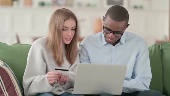 Successful Online Shopping Payment on Laptop By Mixed Race Couple