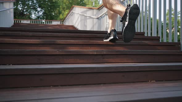 Strong Man Enjoys Running on Wooden Stairs to City Park