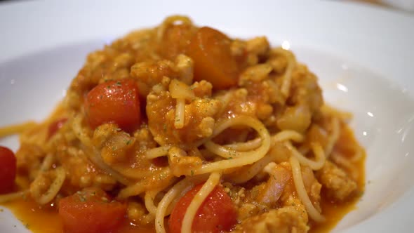 Dolly Orbit Shot of Delicious Italian Spaghetti with Tomato on Top