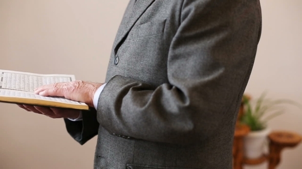 An Old Man Reading The Koran