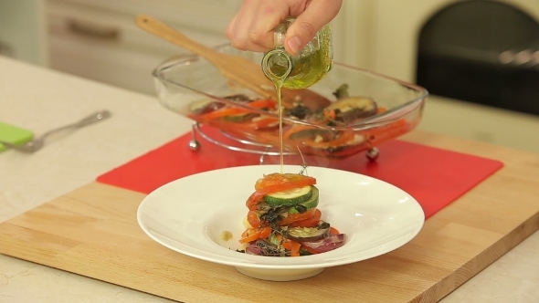Chef Is Serving Freshly Baked Ratatouille On a Plate