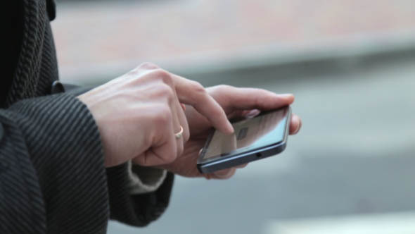  Young Man Dials Sms on the Phone